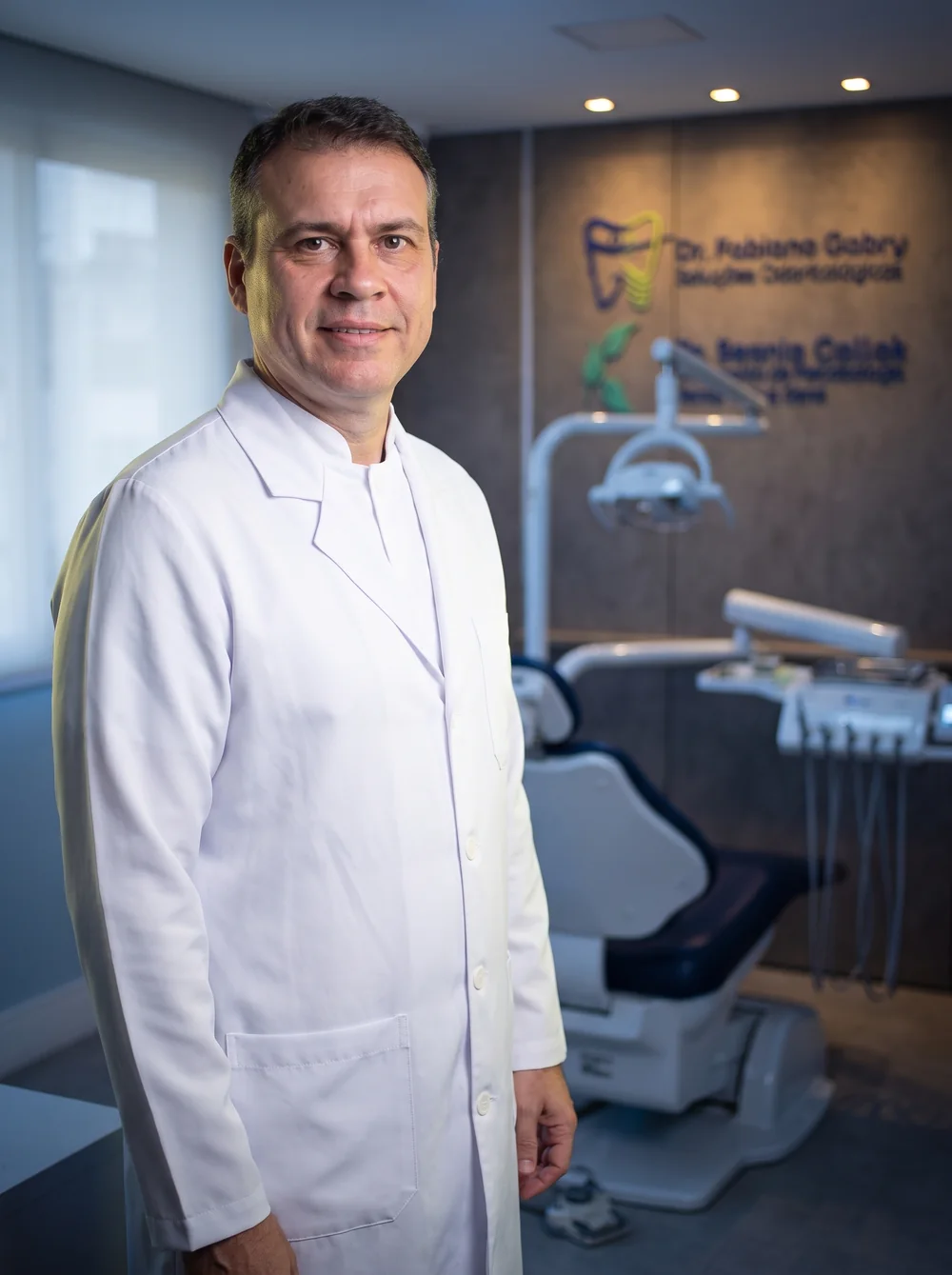 Dr. Fabiano Gabry de jaleco branco no consultório